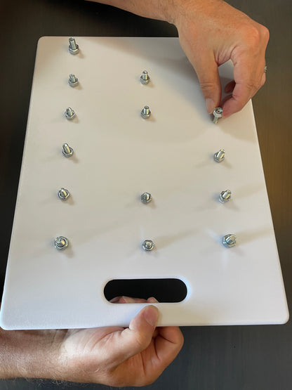 White board with multiple small holes to assemble nuts and bolts activity