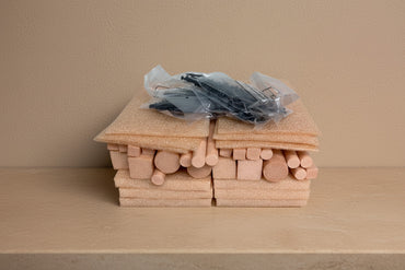 Wooden dowels and hardware on a wooden surface 